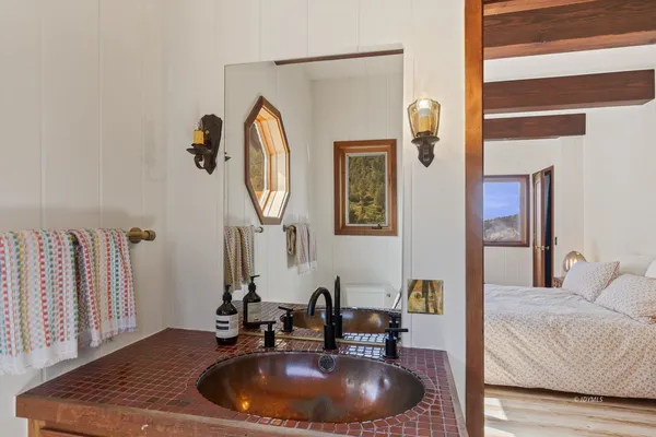 a bathroom with a toilet a sink and a window