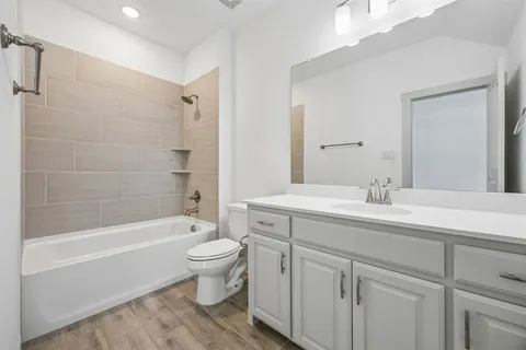 a bathroom with a sink a toilet and a large mirror