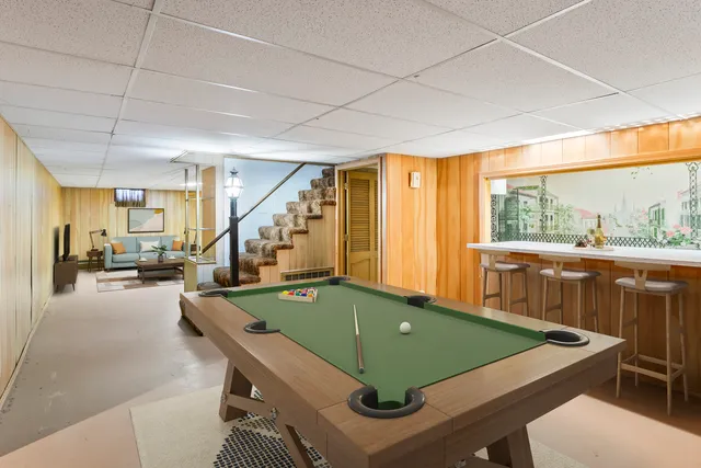 a room with pool table windows and furniture