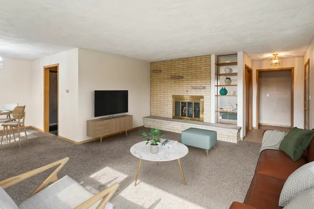 a living room with furniture and a fireplace