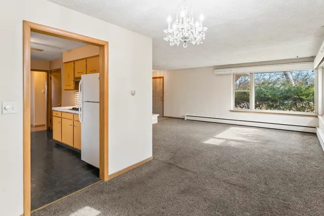 an empty room with windows and entrance