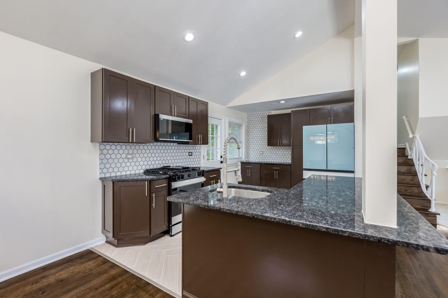 8717 Gross Point Road Skokie, IL 60077 - Photo 12 of 36 a kitchen with granite countertop stainless steel appliances and wooden cabinets