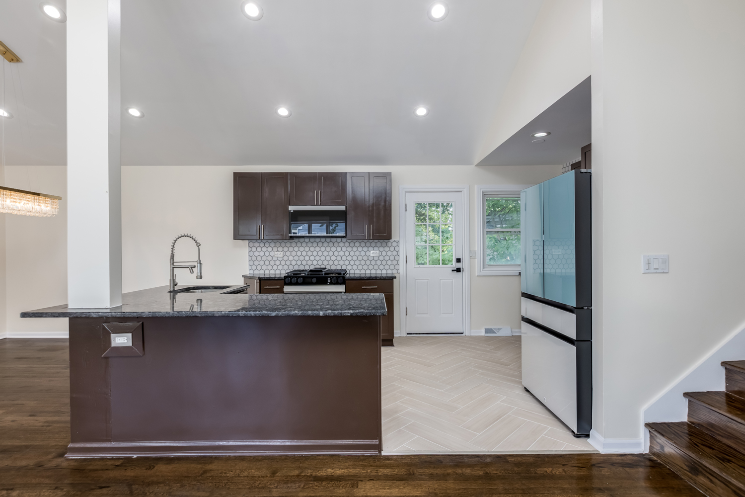 8717 Gross Point Road Skokie, IL 60077 - Photo 13 of 36 a kitchen with stainless steel appliances granite countertop a sink a stove and a refrigerator