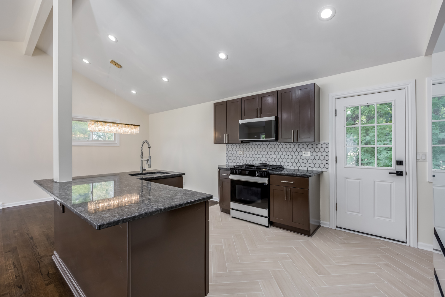 8717 Gross Point Road Skokie, IL 60077 - Photo 15 of 36 a kitchen with kitchen island granite countertop stainless steel appliances and stove top oven