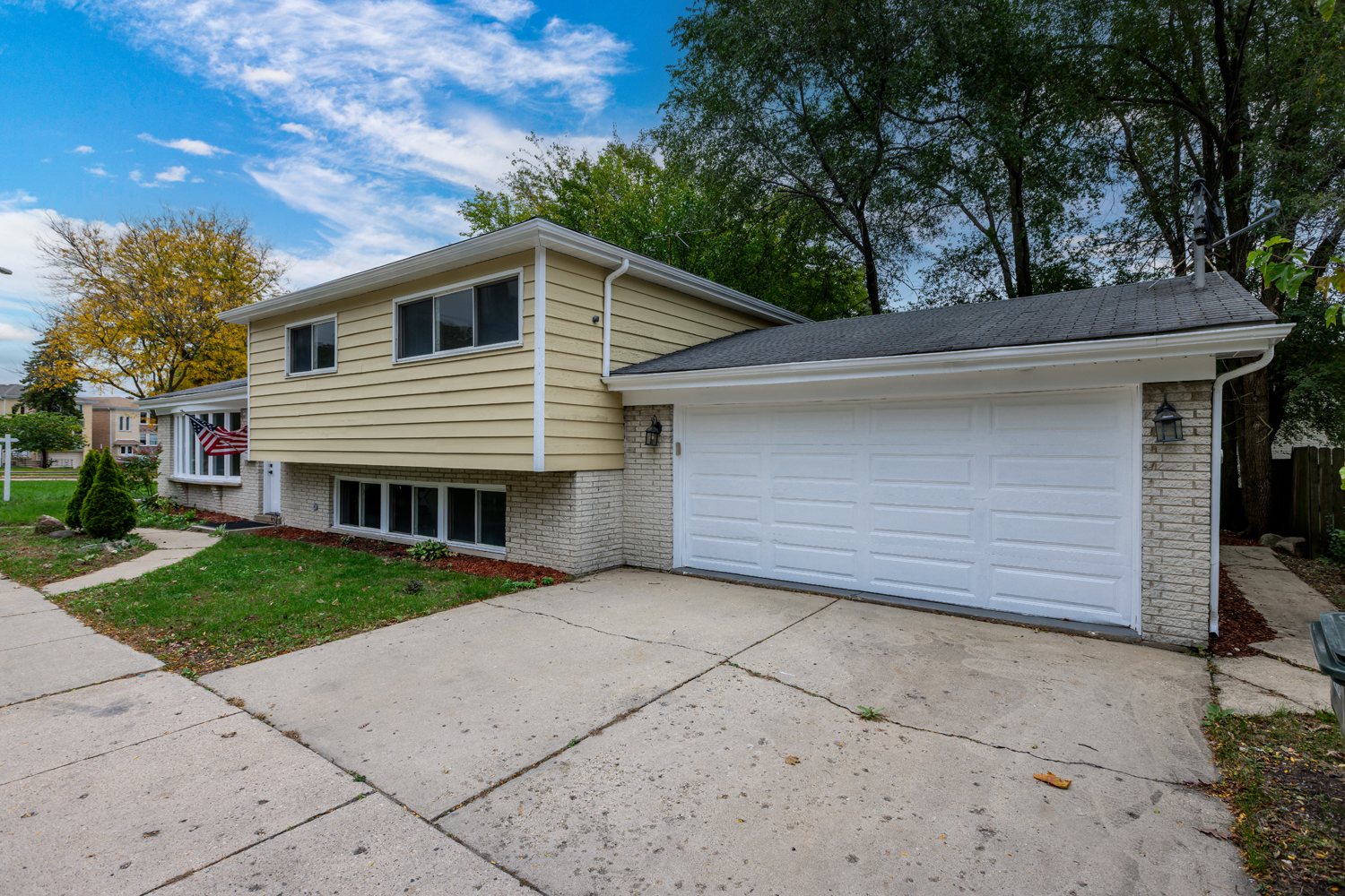 8717 Gross Point Road Skokie, IL 60077 - Photo 2 of 36 a house with a yard and garage