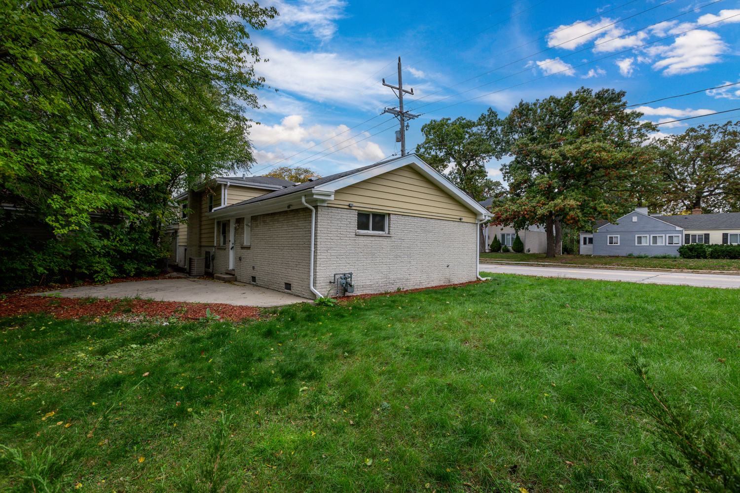 8717 Gross Point Road Skokie, IL 60077 - Photo 34 of 36 a front view of a house with yard and tree