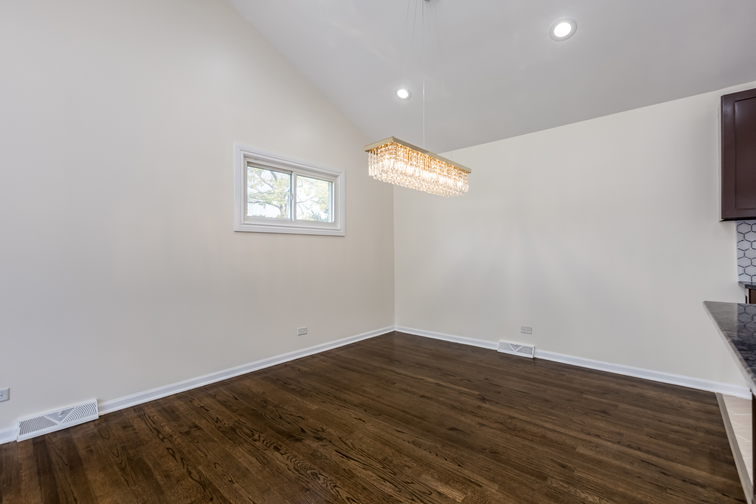 8717 Gross Point Road Skokie, IL 60077 - Photo 8 of 36 an empty room with wooden floor and windows