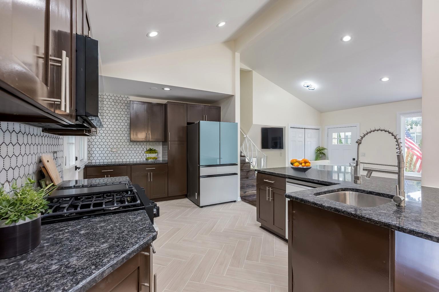 8717 Gross Point Road Skokie, IL 60077 - Photo 10 of 36 a kitchen with stainless steel appliances granite countertop a sink stove and refrigerator