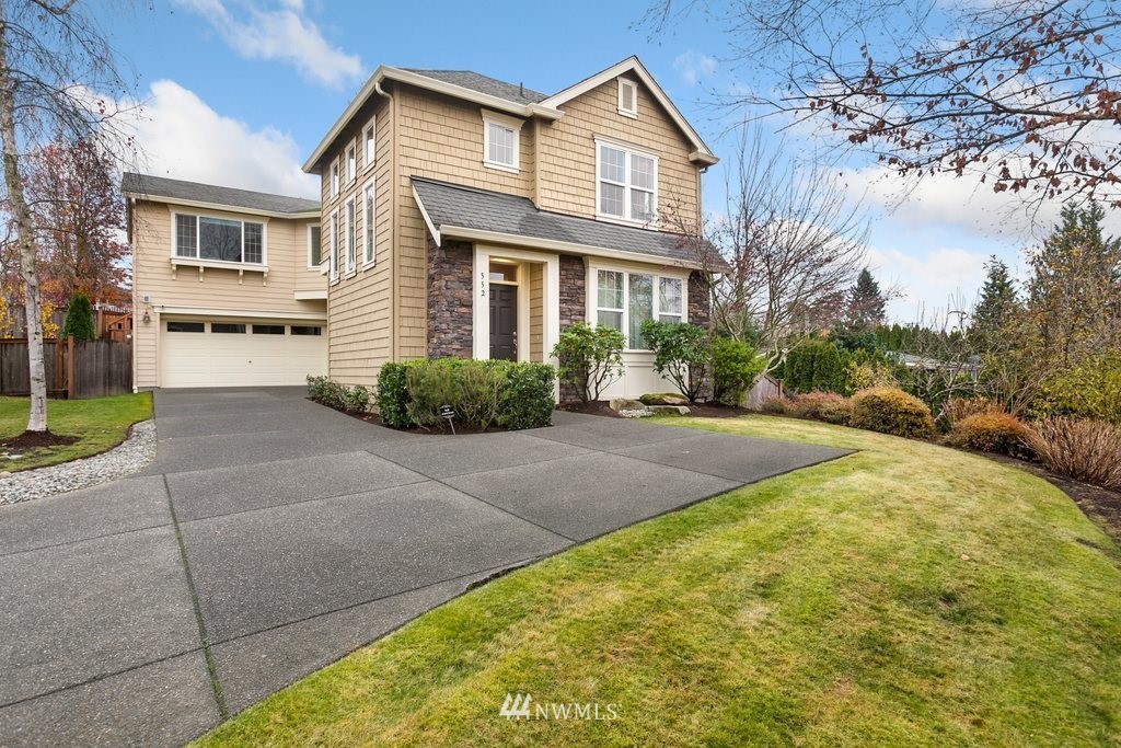 552 Mount Baker Place Northeast Renton, WA 98059 - Photo 1 of 25 a front view of a house with a yard and garage