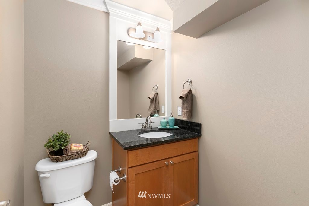 552 Mount Baker Place Northeast Renton, WA 98059 - Photo 12 of 25 a bathroom with a granite countertop sink and a toilet