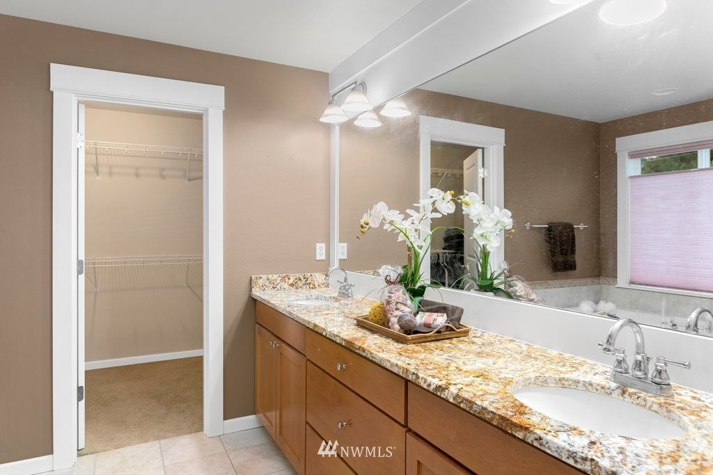 552 Mount Baker Place Northeast Renton, WA 98059 - Photo 15 of 25 a bathroom with a granite countertop sink and a mirror