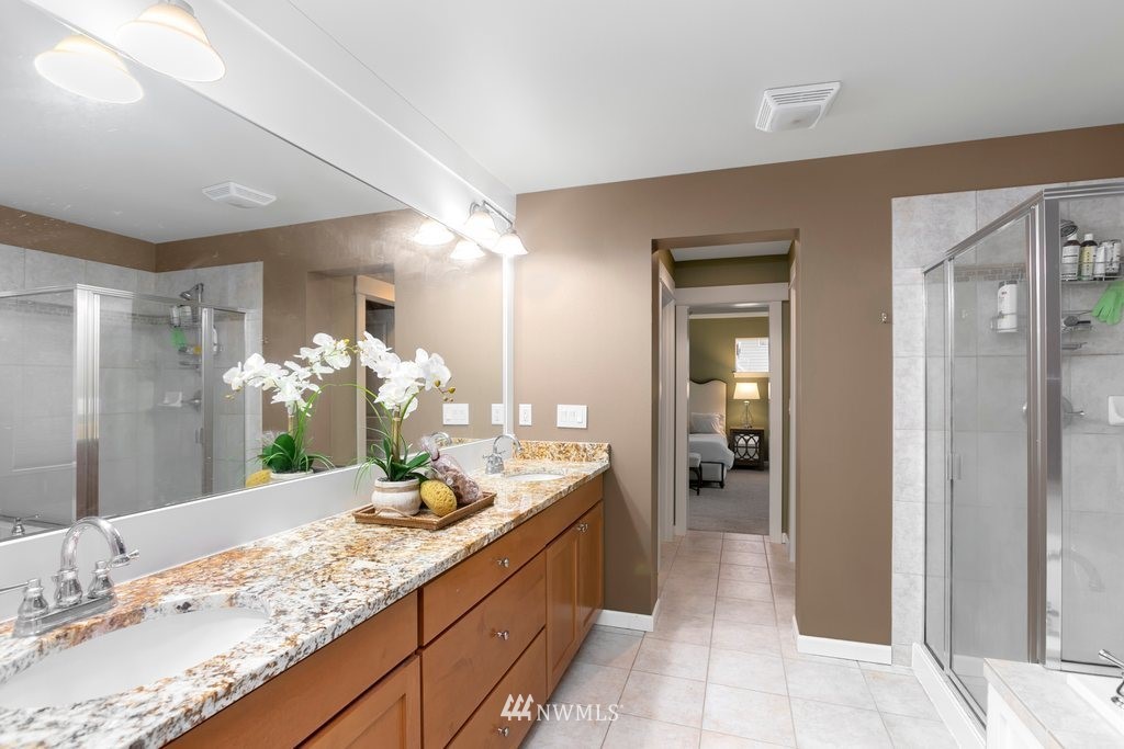 552 Mount Baker Place Northeast Renton, WA 98059 - Photo 18 of 25 a bathroom with a granite countertop sink and a mirror