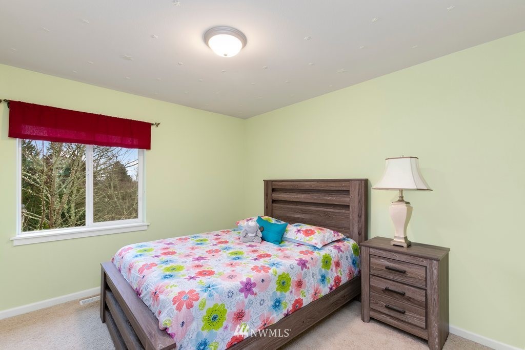 552 Mount Baker Place Northeast Renton, WA 98059 - Photo 20 of 25 a bedroom with a bed and a window
