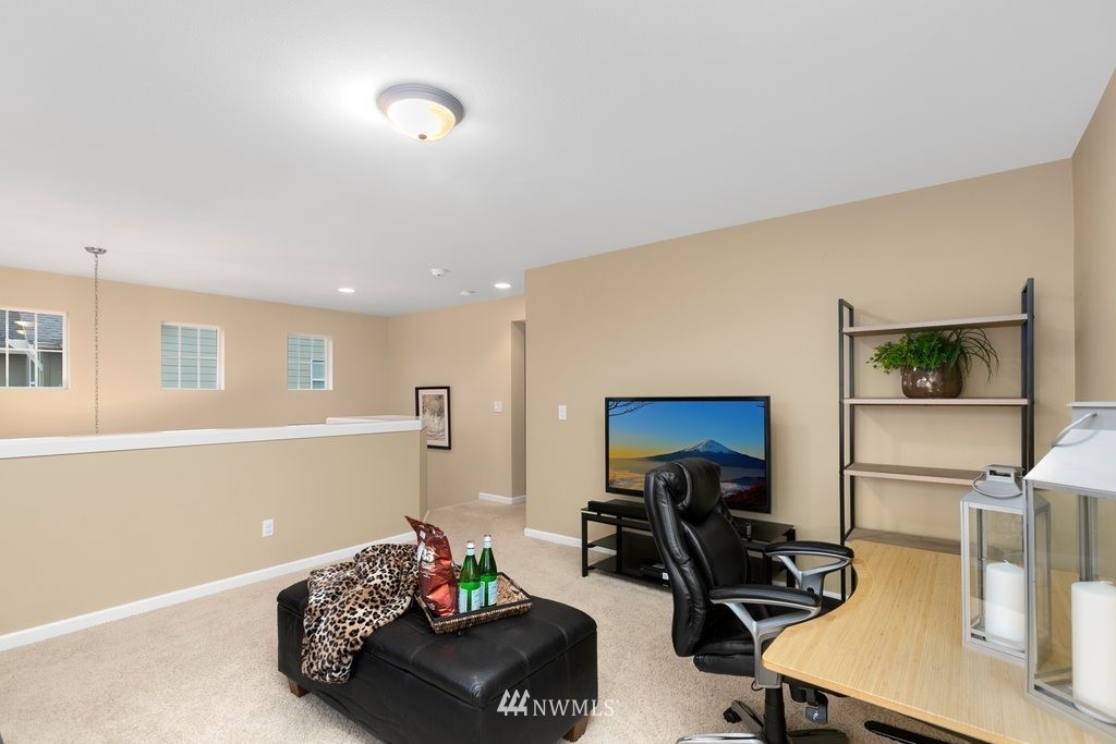 552 Mount Baker Place Northeast Renton, WA 98059 - Photo 22 of 25 a living room with furniture and a flat screen tv