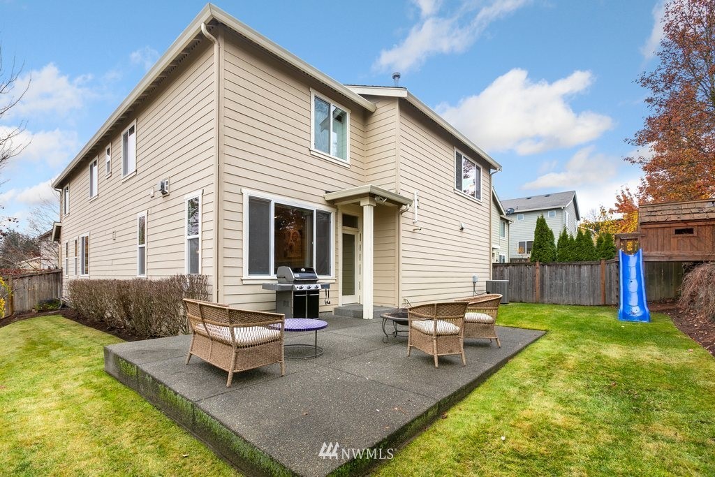 552 Mount Baker Place Northeast Renton, WA 98059 - Photo 24 of 25 a backyard of a house with barbeque oven table and chairs
