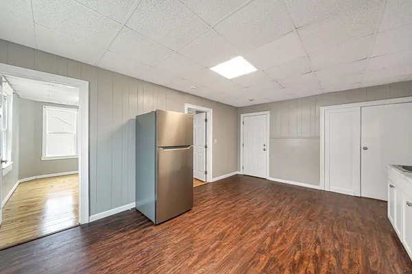 a view of empty room with wooden floor