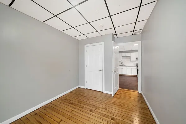 a view of empty room with wooden floor