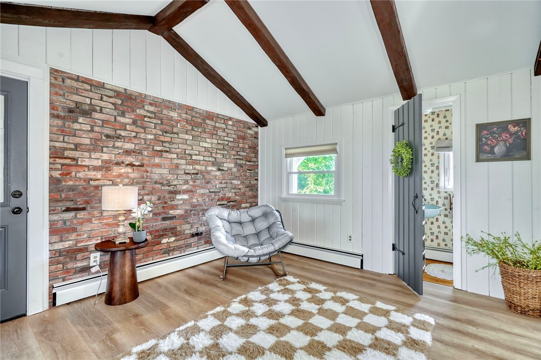 1023 Brown Road Irondequoit, NY 14622 - Photo 19 of 46 Vaulted bonus room with beams, brick wall, and sli