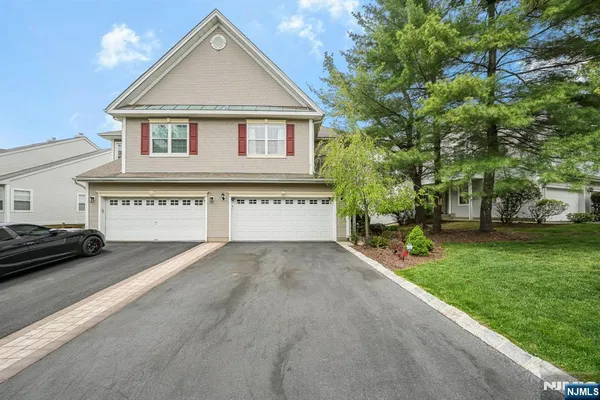 a view of a house with a yard and garage