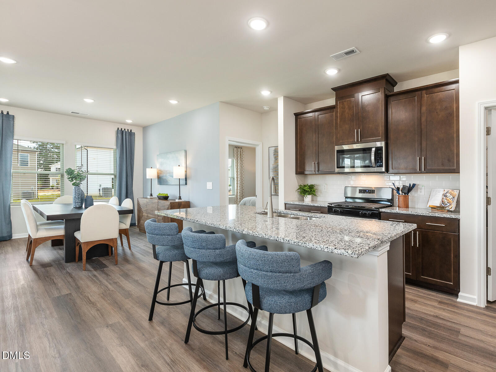 92 Thistle Patch Place Angier, NC 27501 - Photo 13 of 24 a kitchen with a dining table chairs and wooden floor
