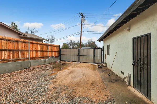 a view of backyard with wooden fence