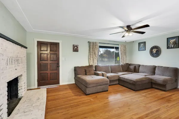 a living room with furniture a flat screen tv and a fireplace
