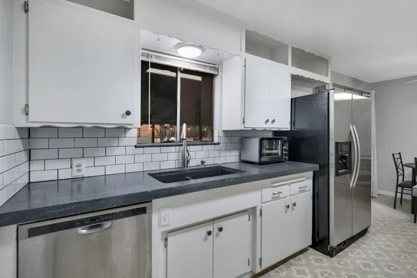 a kitchen with stainless steel appliances granite countertop a sink and cabinets