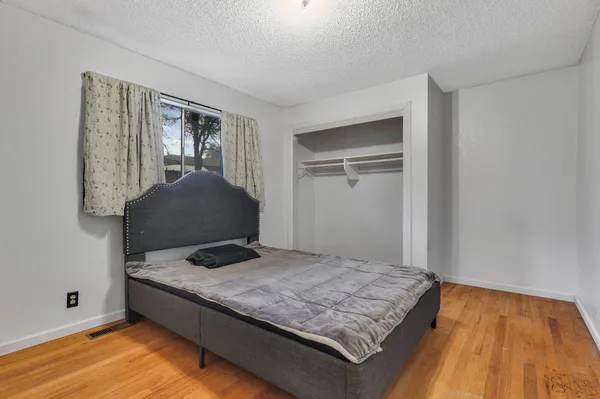 a bedroom with a bed and window