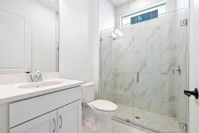 a bathroom with a sink toilet and shower