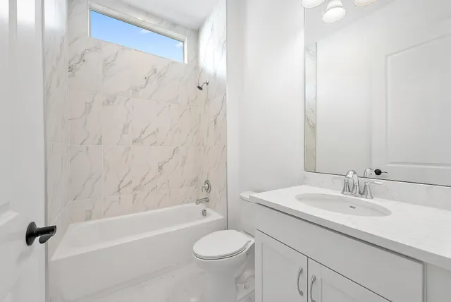 a view of a room with a ceiling fan and bathroom