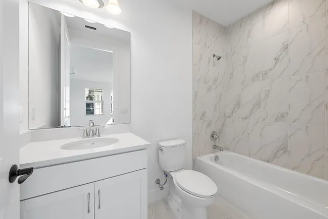 a view of a house with a yard and potted plants