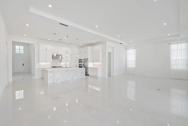 a view of kitchen with refrigerator and window