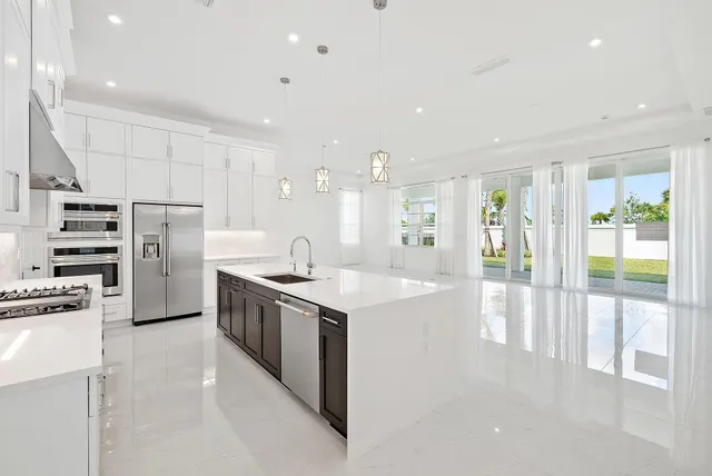 a kitchen with stainless steel appliances a sink stove and cabinets