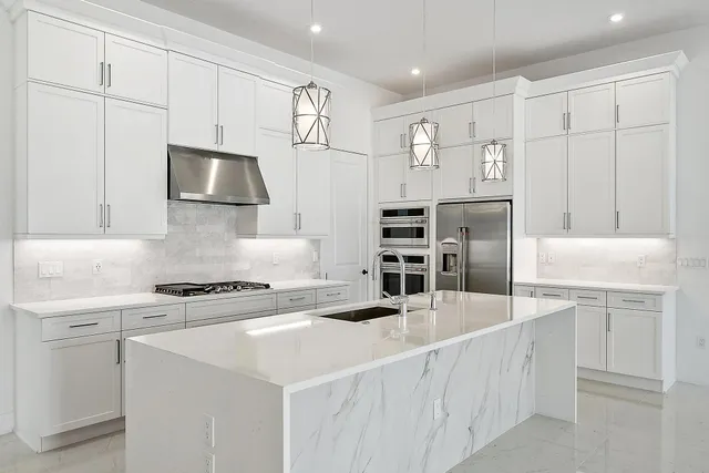 a kitchen with cabinets and stainless steel appliances