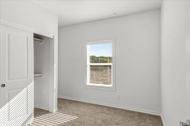 a view of a room with wooden floor and closet