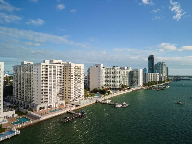 a view of a lake with houses in the back