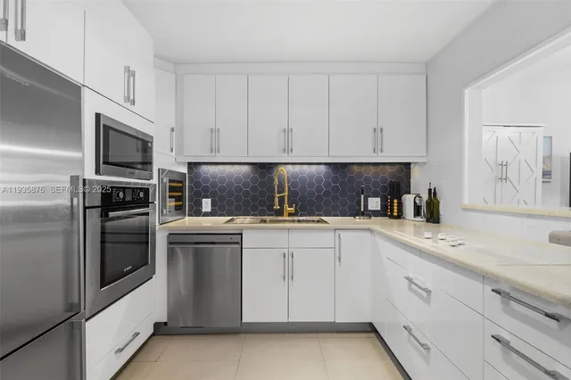 a kitchen with cabinets appliances and a sink