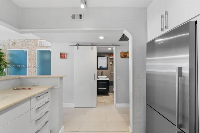 a view of cabinets with stainless steel appliances kitchen island