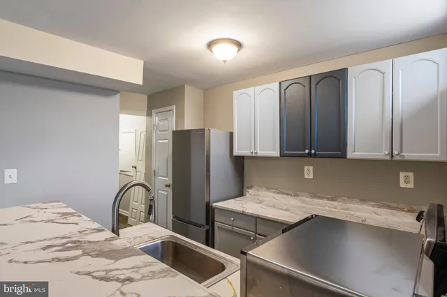a kitchen with a refrigerator and a sink