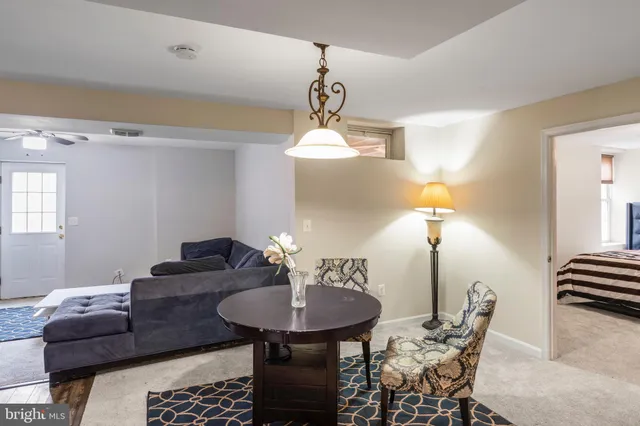 a view of a dining room with furniture and chandelier