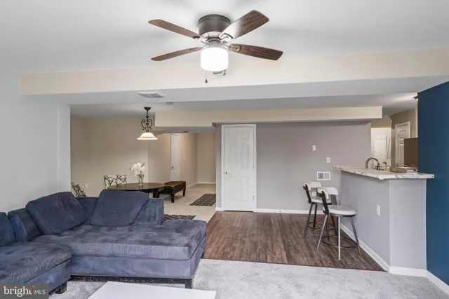 a living room with furniture and a chandelier