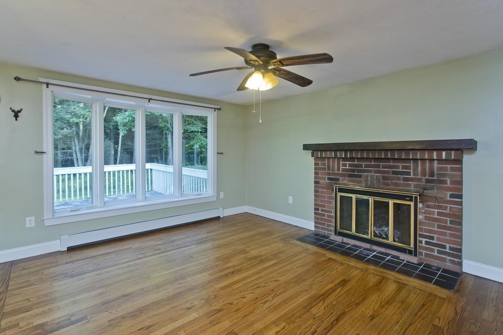 27 Searle Road Huntington, MA 01050 - Photo 12 of 32 a view of an empty room with wooden floor fireplace and a window