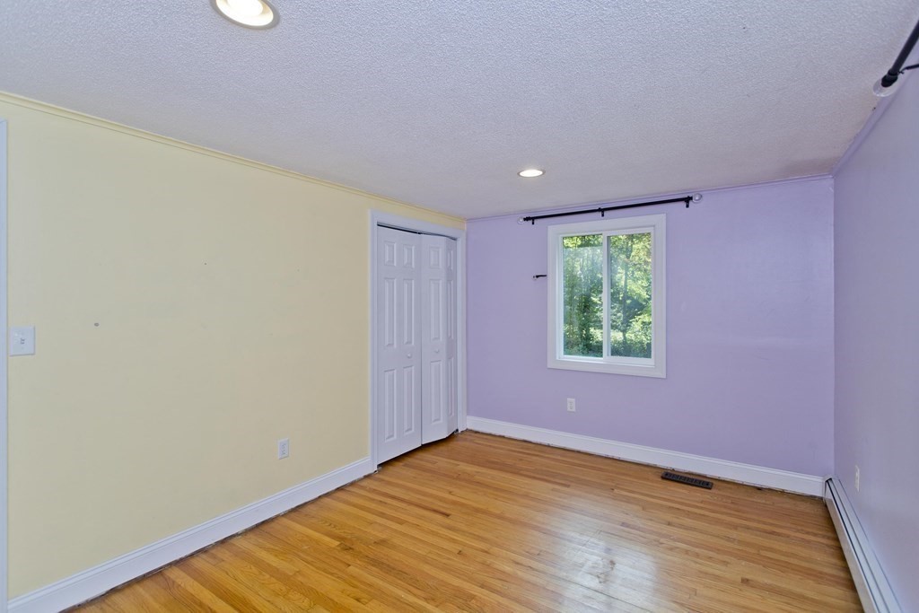 27 Searle Road Huntington, MA 01050 - Photo 19 of 32 a view of an empty room with wooden floor and a window