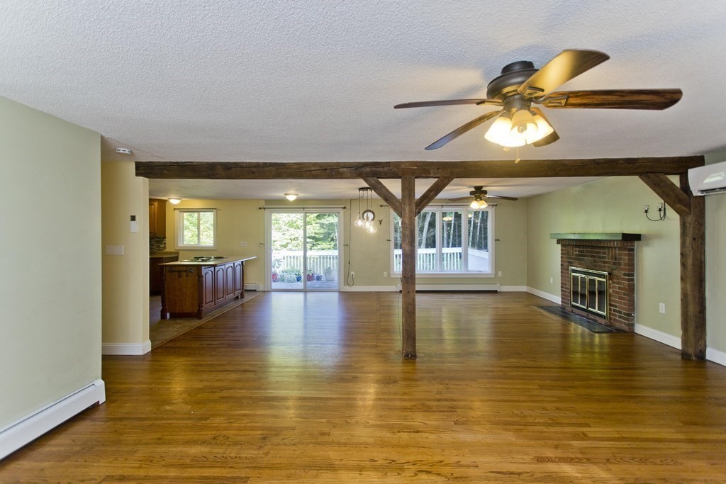 27 Searle Road Huntington, MA 01050 - Photo 2 of 32 a view of a living room with kitchen view and a fireplace