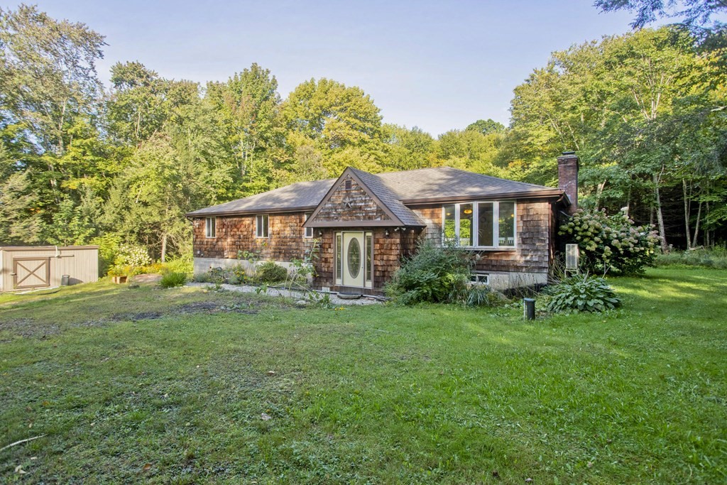 27 Searle Road Huntington, MA 01050 - Photo 32 of 32 a front view of a house with a garden and porch