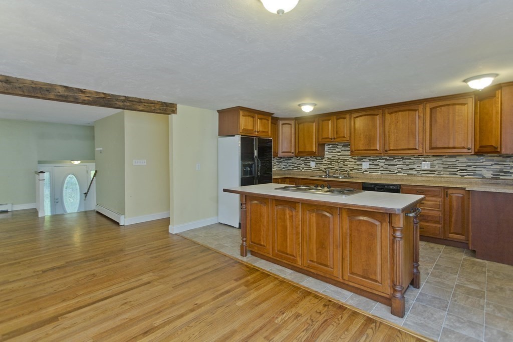 27 Searle Road Huntington, MA 01050 - Photo 4 of 32 a kitchen with stainless steel appliances granite countertop a sink stove and cabinets