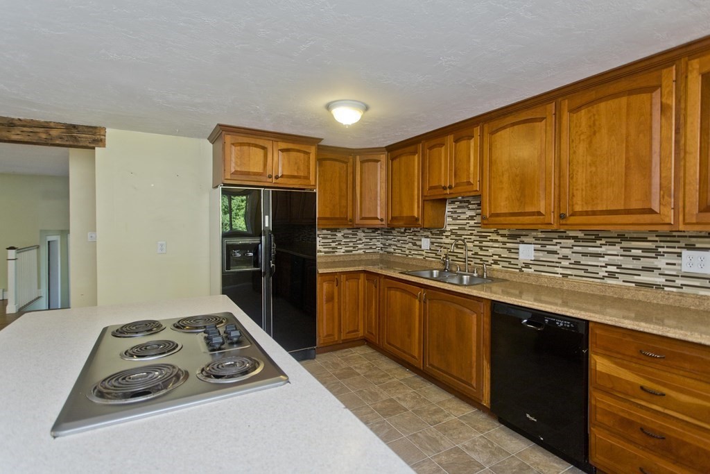 27 Searle Road Huntington, MA 01050 - Photo 5 of 32 a kitchen with granite countertop a sink stove and refrigerator