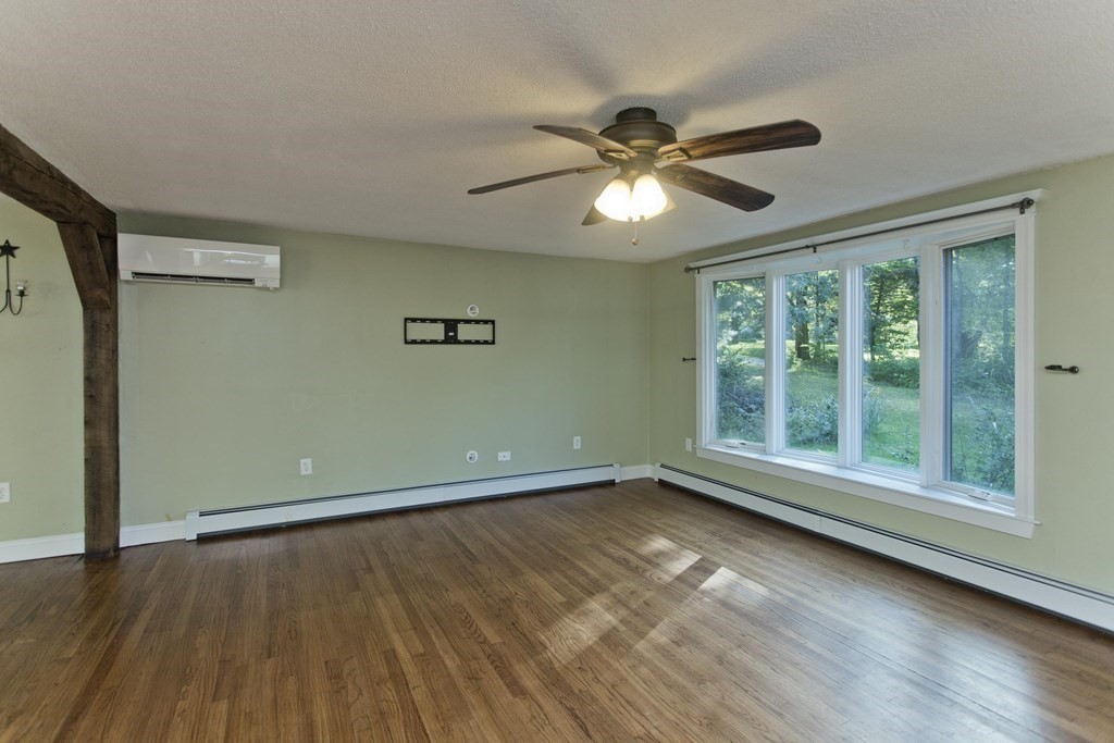 27 Searle Road Huntington, MA 01050 - Photo 9 of 32 a view of an empty room with wooden floor and a window