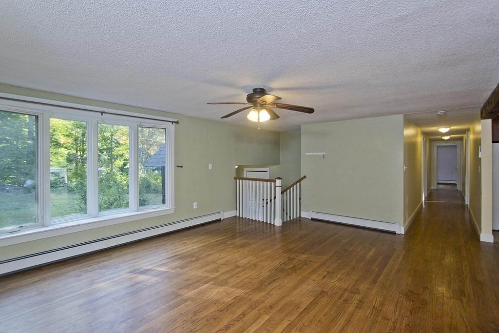 27 Searle Road Huntington, MA 01050 - Photo 10 of 32 a view of empty room with wooden floor and fan