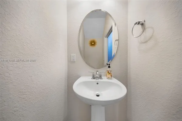 a bathroom with a sink and mirror